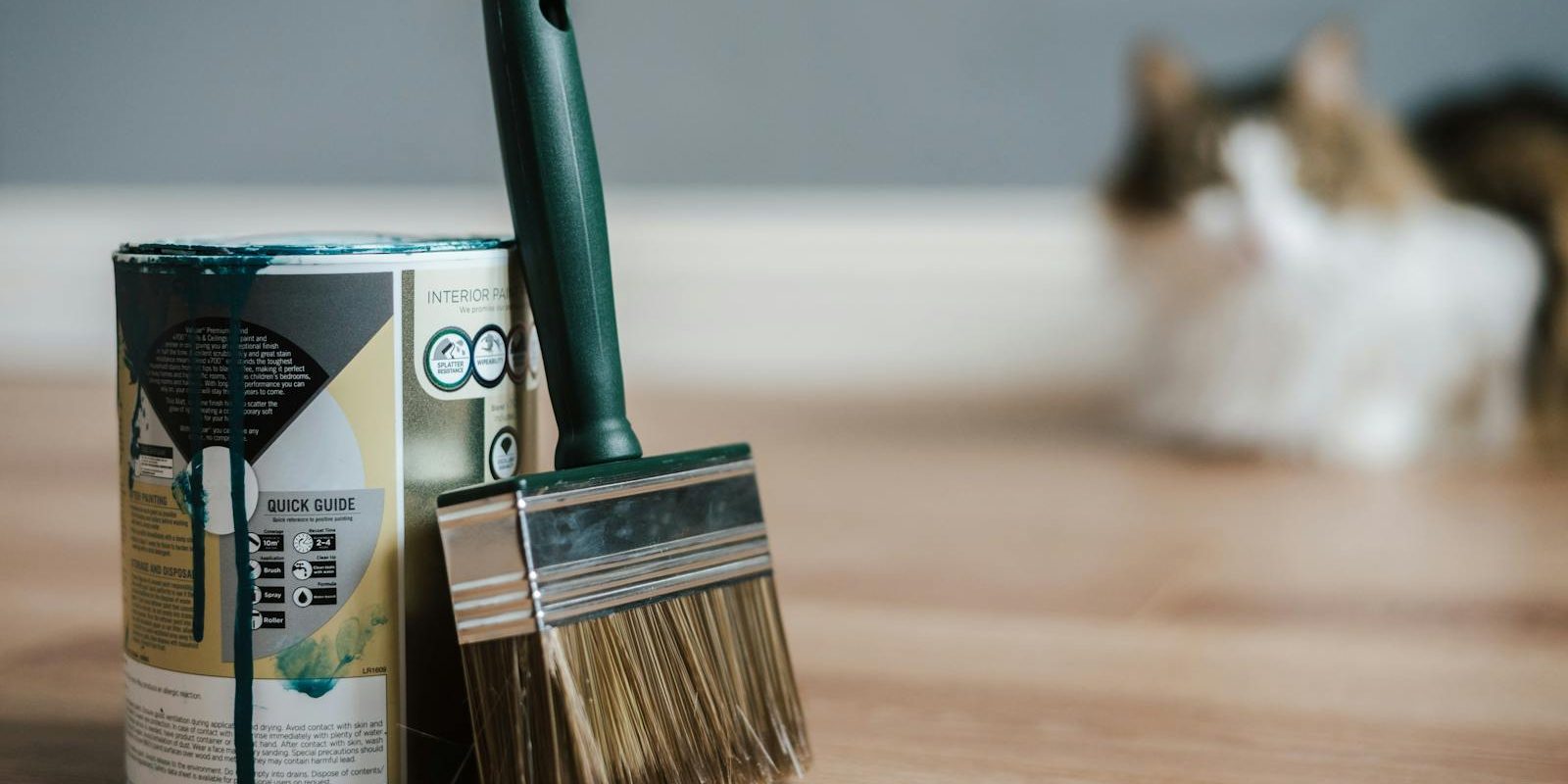 Paint brush near can on floor at home