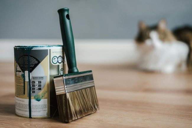 Photo by Anete Lusina Paint brush near can on floor at home