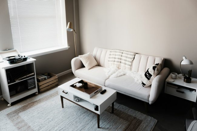 Photo by ian dooley white couch in front of white wooden table